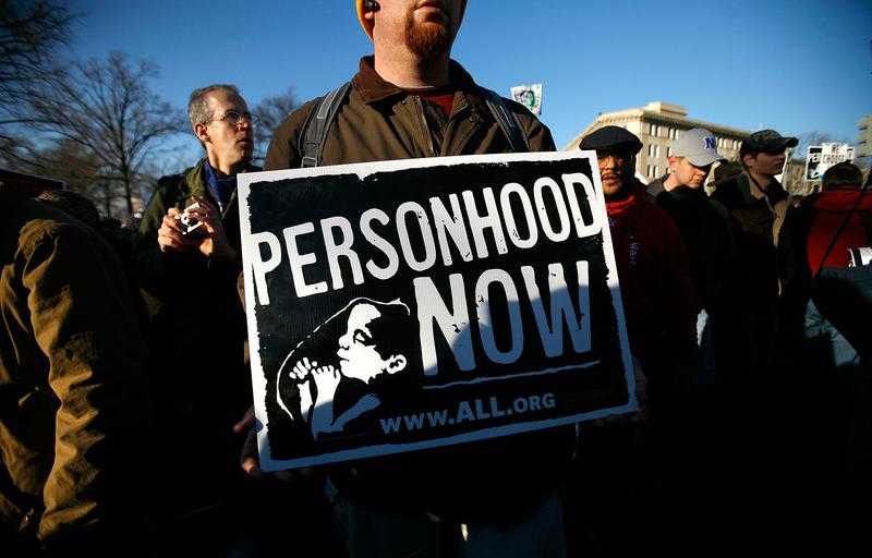 A pro-life activist holds a sign as he participates in the annual 'March for Life' event in Washington, DC.